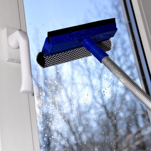 How to clean glass windows at home - a squeegee used for cleaning the window