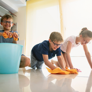 Creative Ways to get kids to clean up -Three kids cleaning the floor